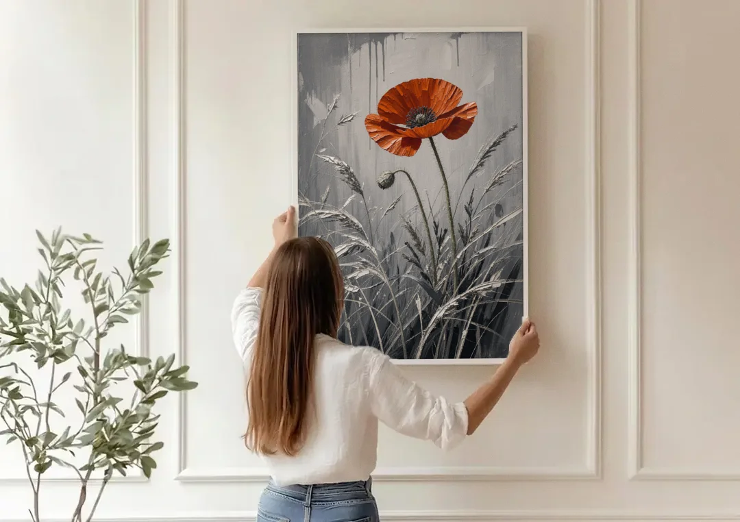 Red Black White Wall Art of a Lone Poppy canvas wall art being hung on a paneled wall