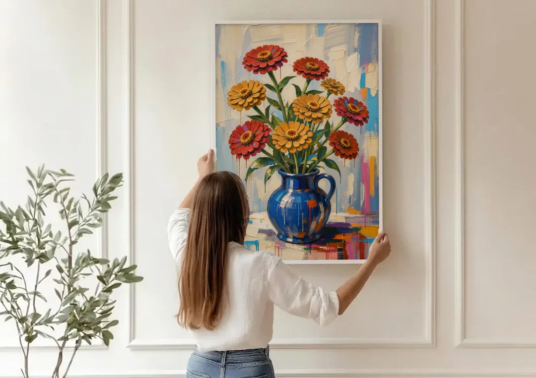 Red Floral Wall Art of Zinnias in a Cobalt Jug canvas wall art being hung on a paneled wall