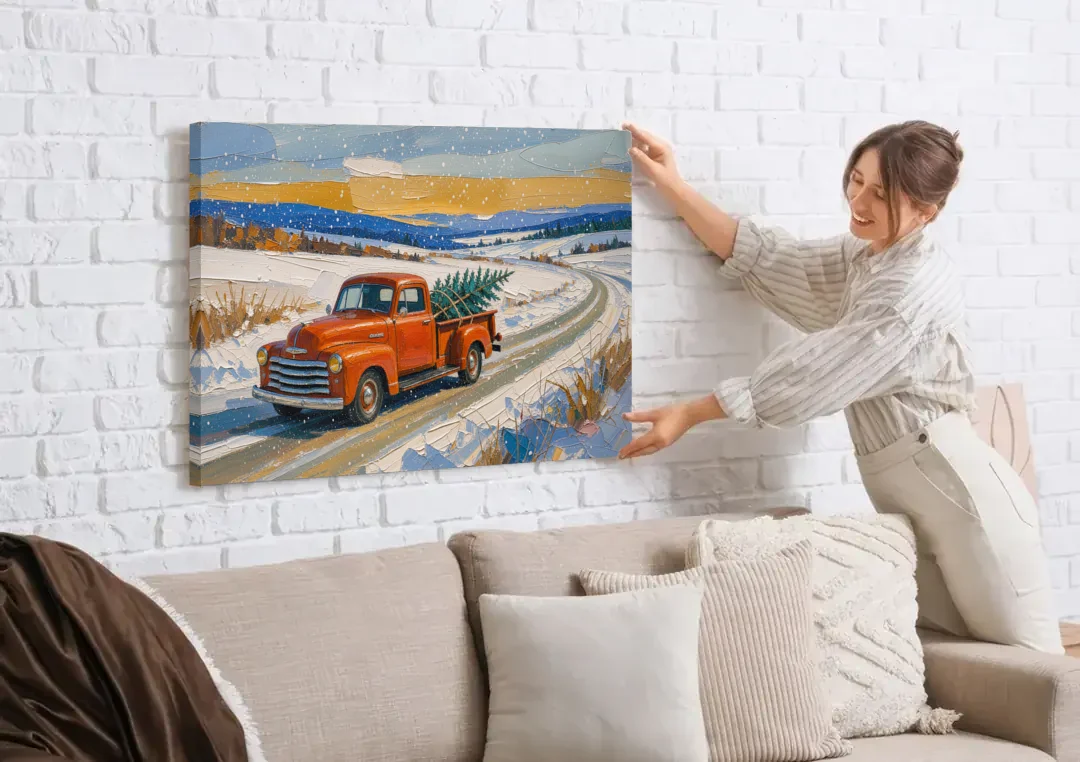 Red Truck Christmas Tree Painting on Country Road canvas wall art being hung on a white brick wall above a sofa
