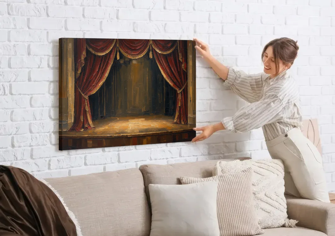 Red Velvet Curtains Framing an Empty Lit Stage canvas wall art being hung on a white brick wall above a sofa
