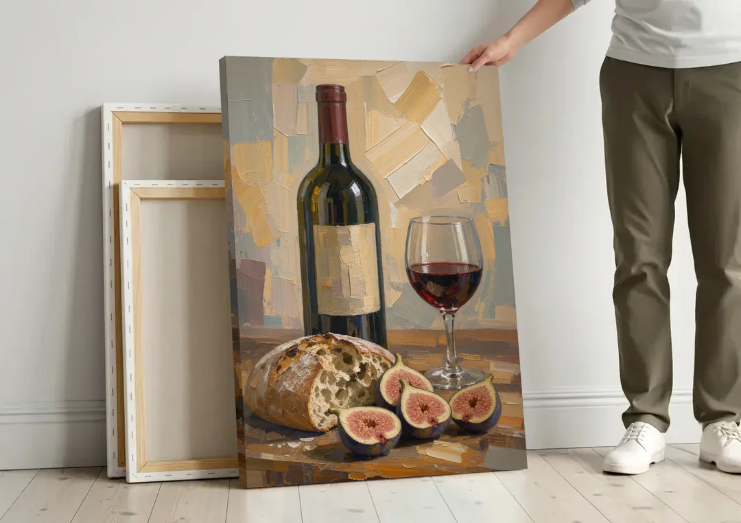 Red Wine Painting with Bread and Figs canvas wall art leaning against a wall next to blank canvases