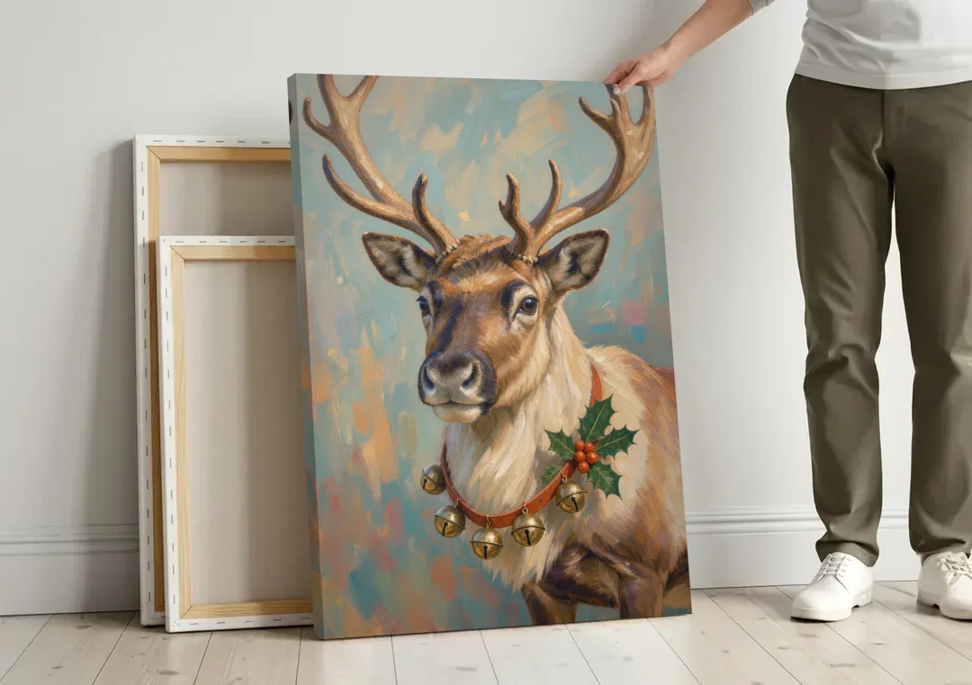 Reindeer with Jingle Bell Collar and Holly canvas wall art leaning against a wall next to blank canvases