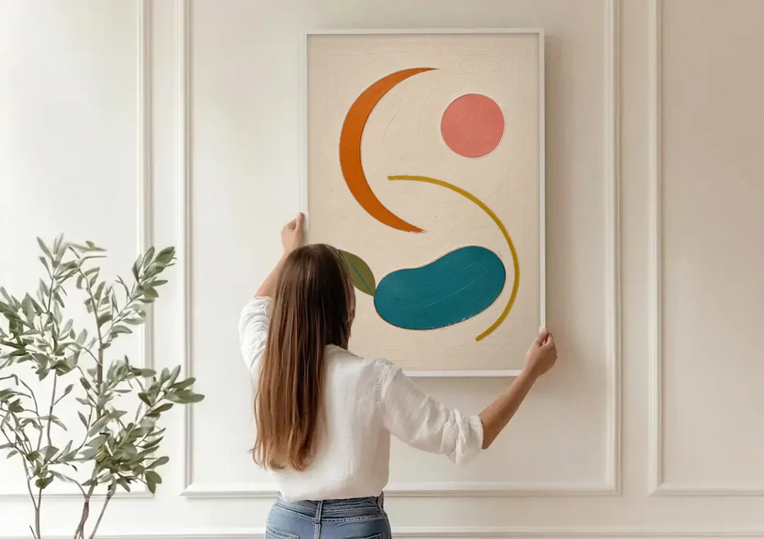 Retro Wall Decor with Teal Pebble and Coral Sun canvas wall art being hung on a paneled wall