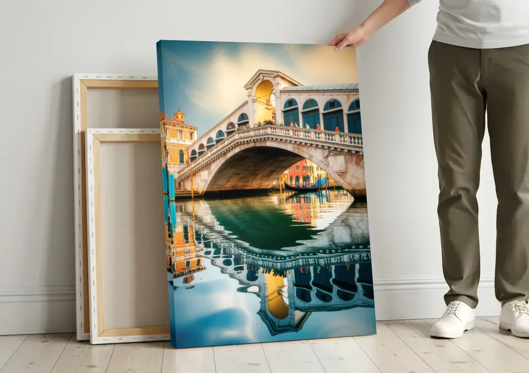 Rialto Bridge Reflections canvas wall art leaning against a wall next to blank canvases