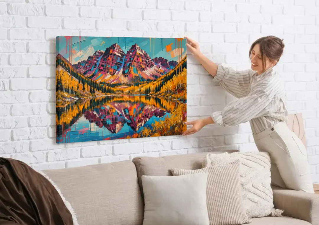 Rocky Mountains Painting of Maroon Bells canvas wall art being hung on a white brick wall above a sofa