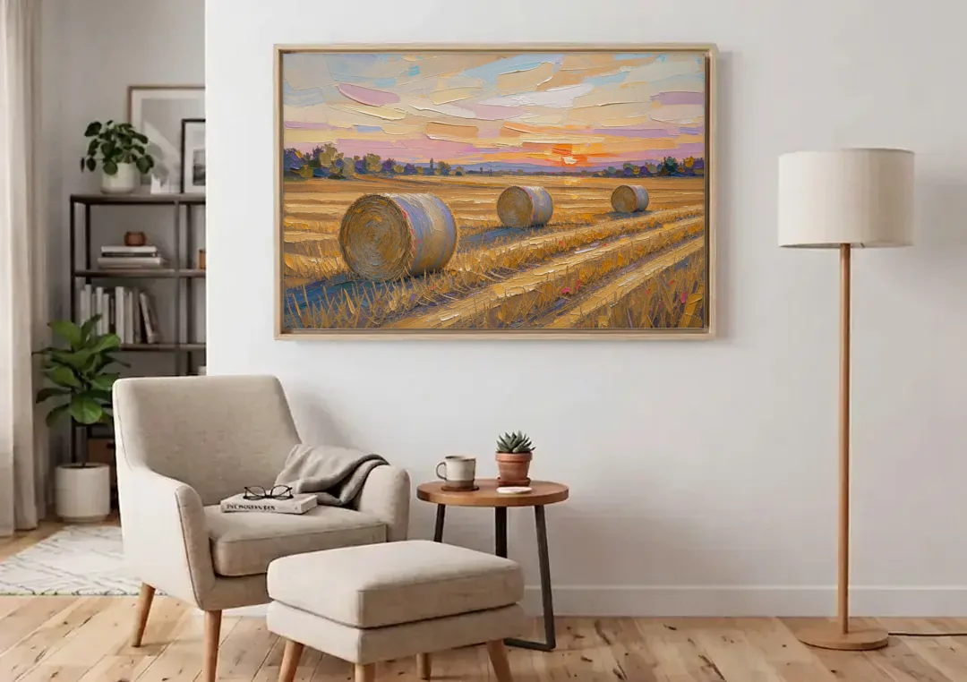 Round Hay Bales on a Golden Harvest Field canvas wall art above an armchair in a bright living room