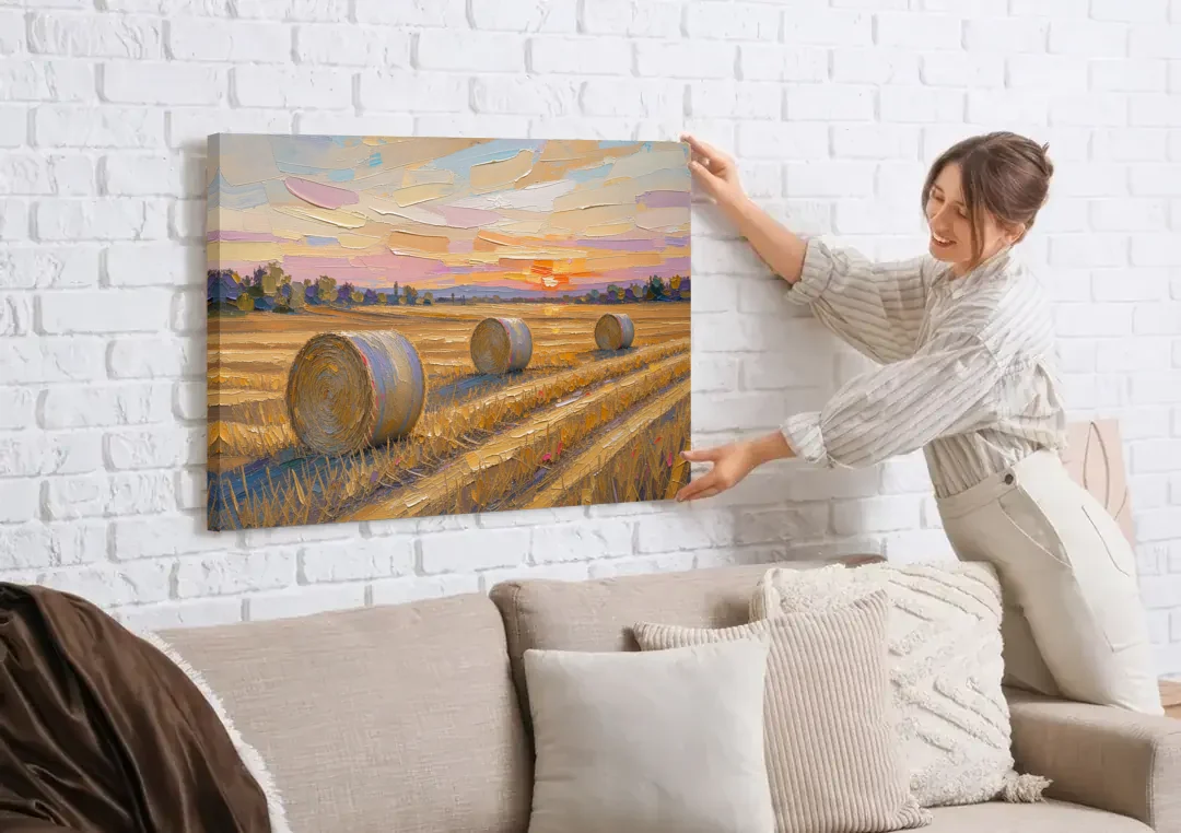 Round Hay Bales on a Golden Harvest Field canvas wall art being hung on a white brick wall above a sofa