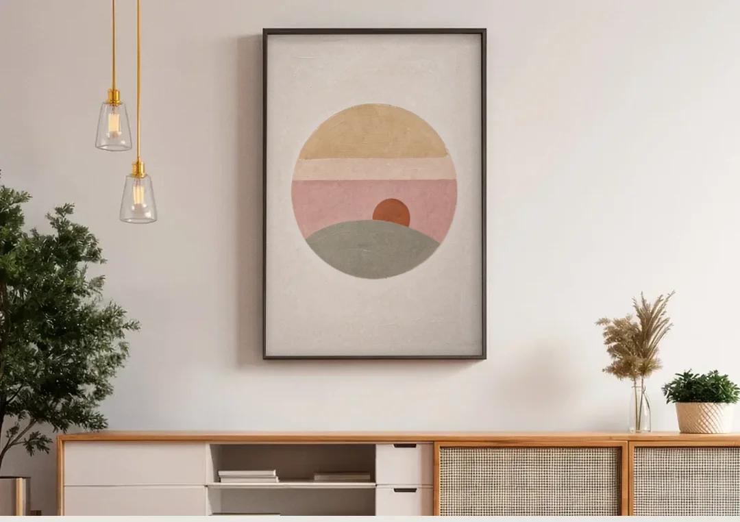 Round Window Landscape with Low Rust Sun canvas wall art above a wooden sideboard under pendant lights