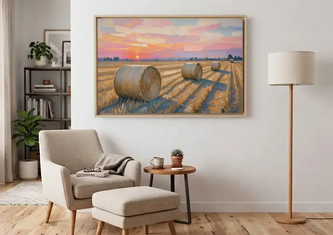 Rural Landscape Painting of Hay Bales at Sunset canvas wall art above an armchair in a bright living room