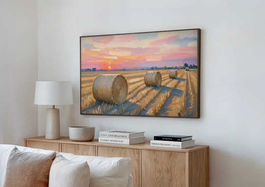Rural Landscape Painting of Hay Bales at Sunset canvas wall art above a wooden sideboard next to a sofa