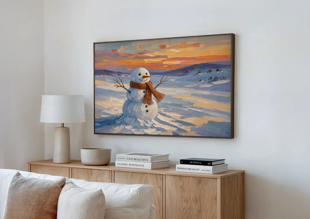 Rust Scarf Snowman at Dusk in Winter canvas wall art above a wooden sideboard next to a sofa