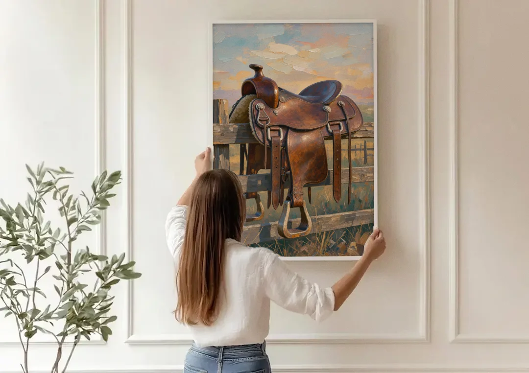 Rustic Western Wall Decor with Saddle at Sundown canvas wall art being hung on a paneled wall