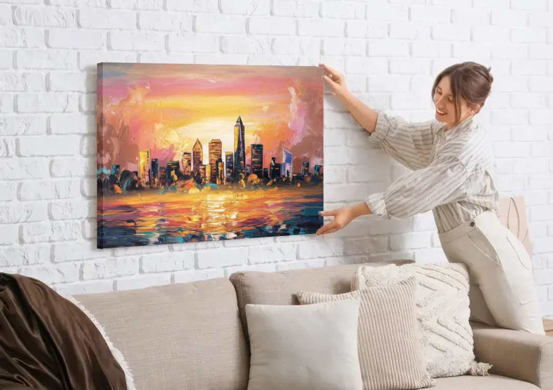 Salem Skyline Sunset canvas wall art being hung on a white brick wall above a sofa