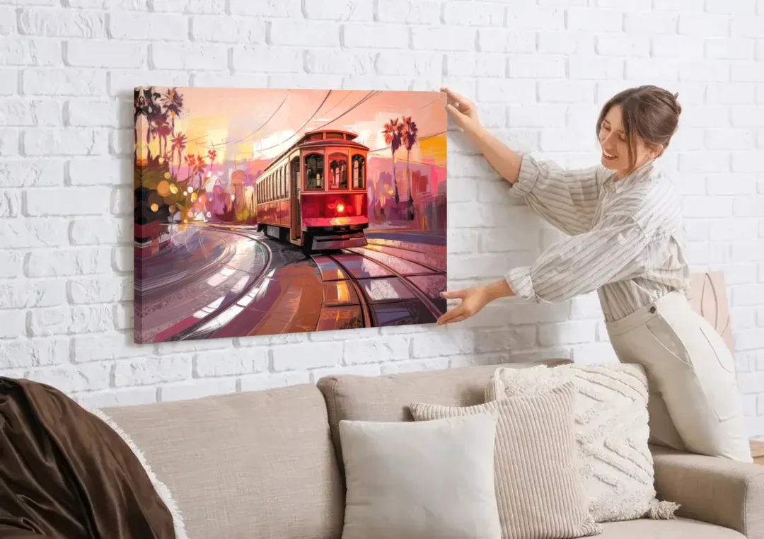 San Diego Trolley At Sunset canvas wall art being hung on a white brick wall above a sofa