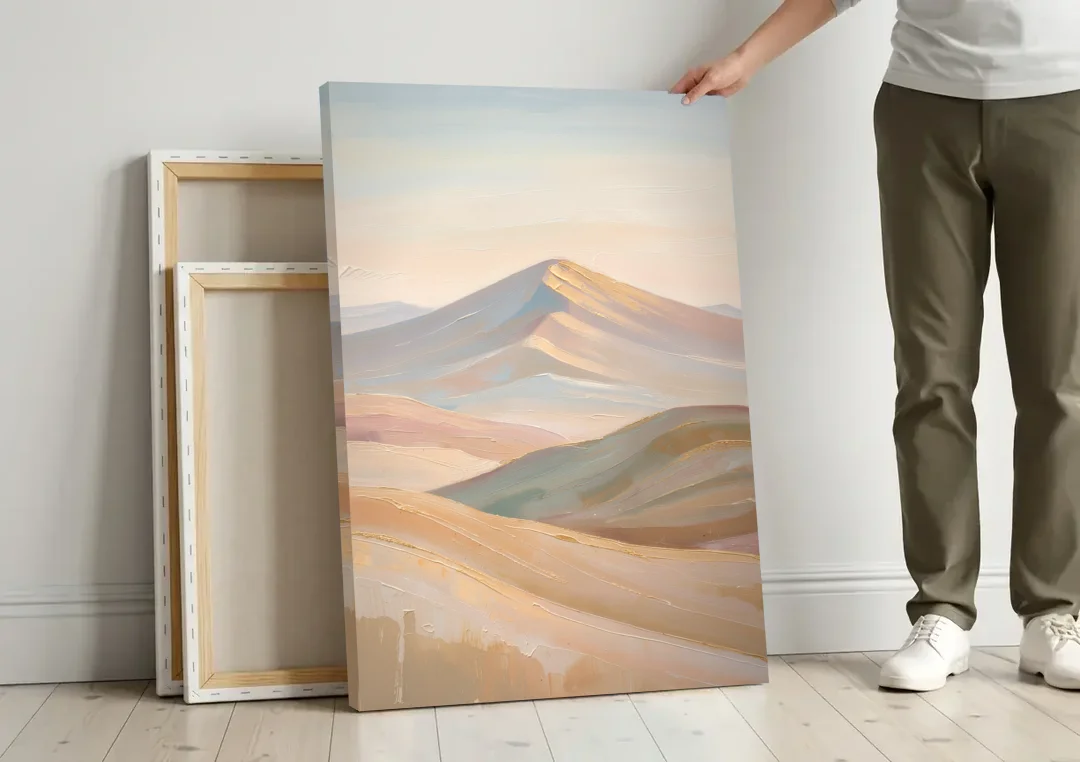 Neutral Sand and Sage Mountain Highlands canvas wall art leaning against a wall next to blank canvases