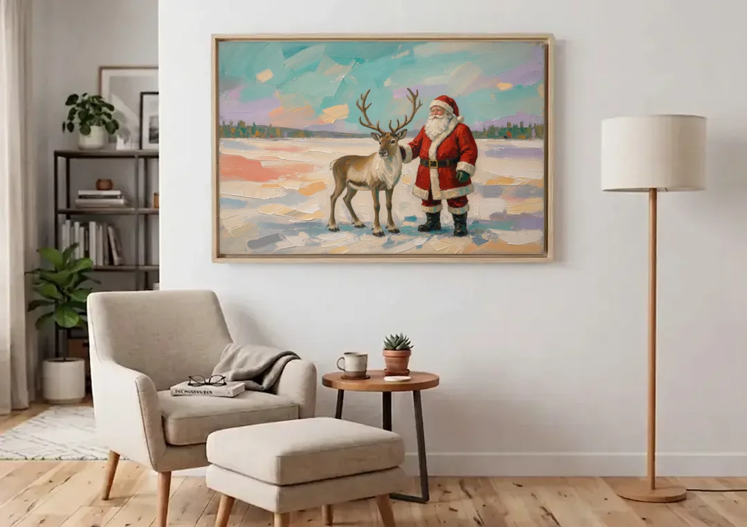 Santa and Reindeer Painting on the Open Snow canvas wall art above an armchair in a bright living room