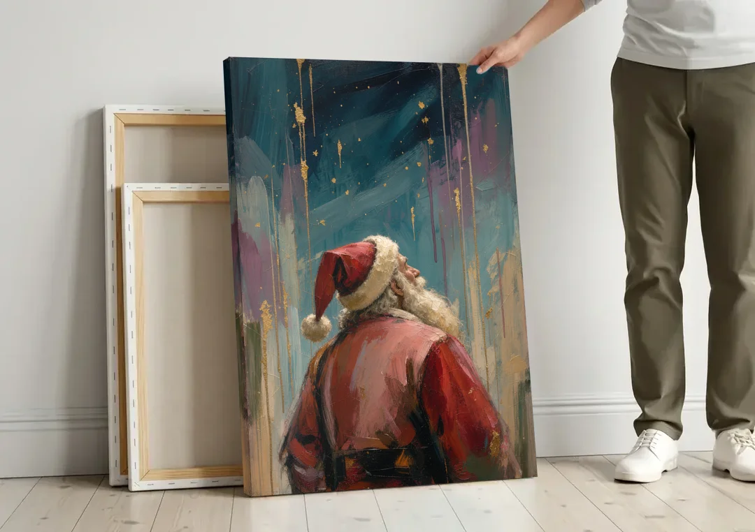 Contemporary Christmas Santa Under Gold Stars canvas wall art leaning against a wall next to blank canvases