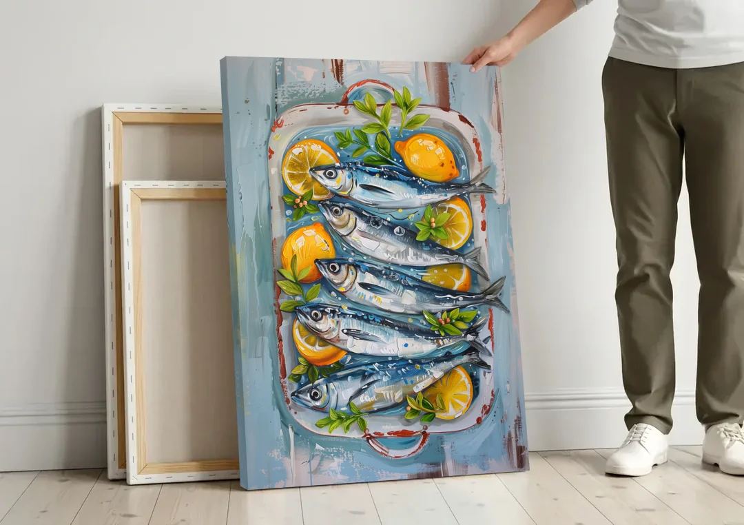 Sardines Painting with Lemon Slices canvas wall art leaning against a wall next to blank canvases