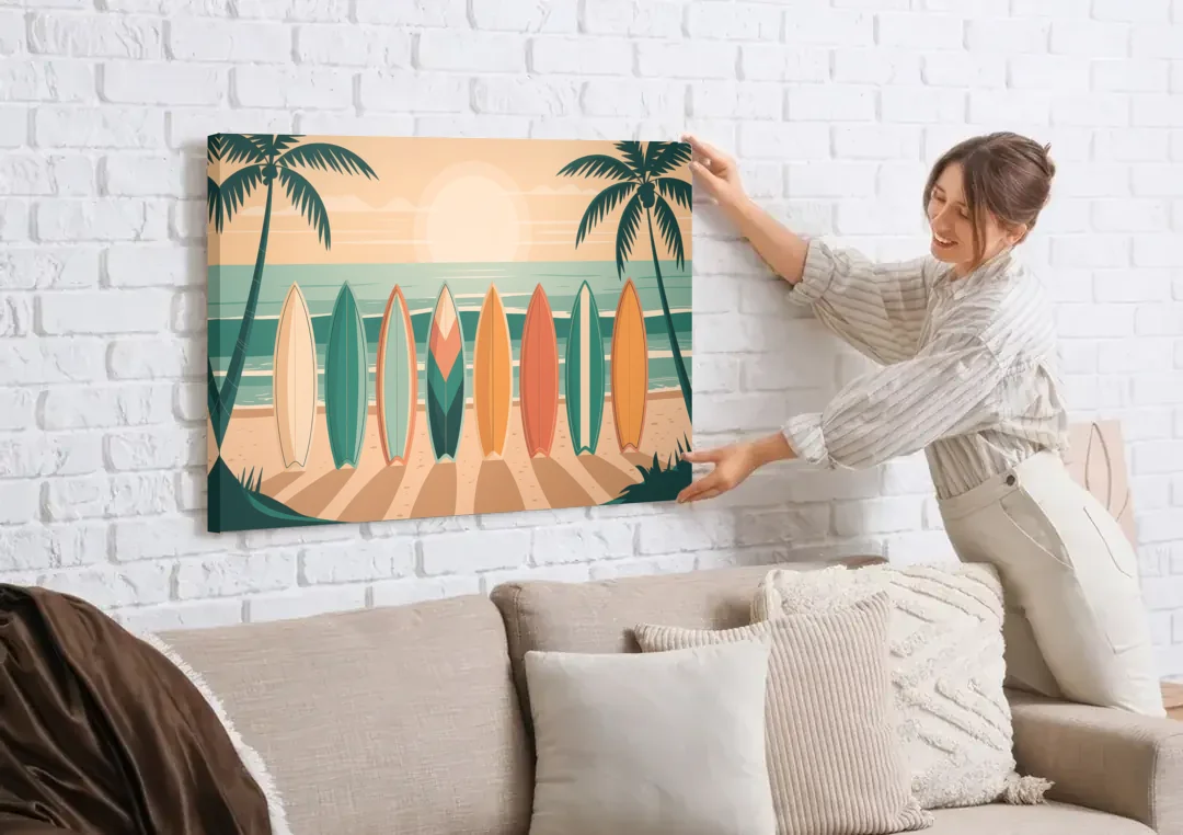 Sayulita Surfboards canvas wall art being hung on a white brick wall above a sofa