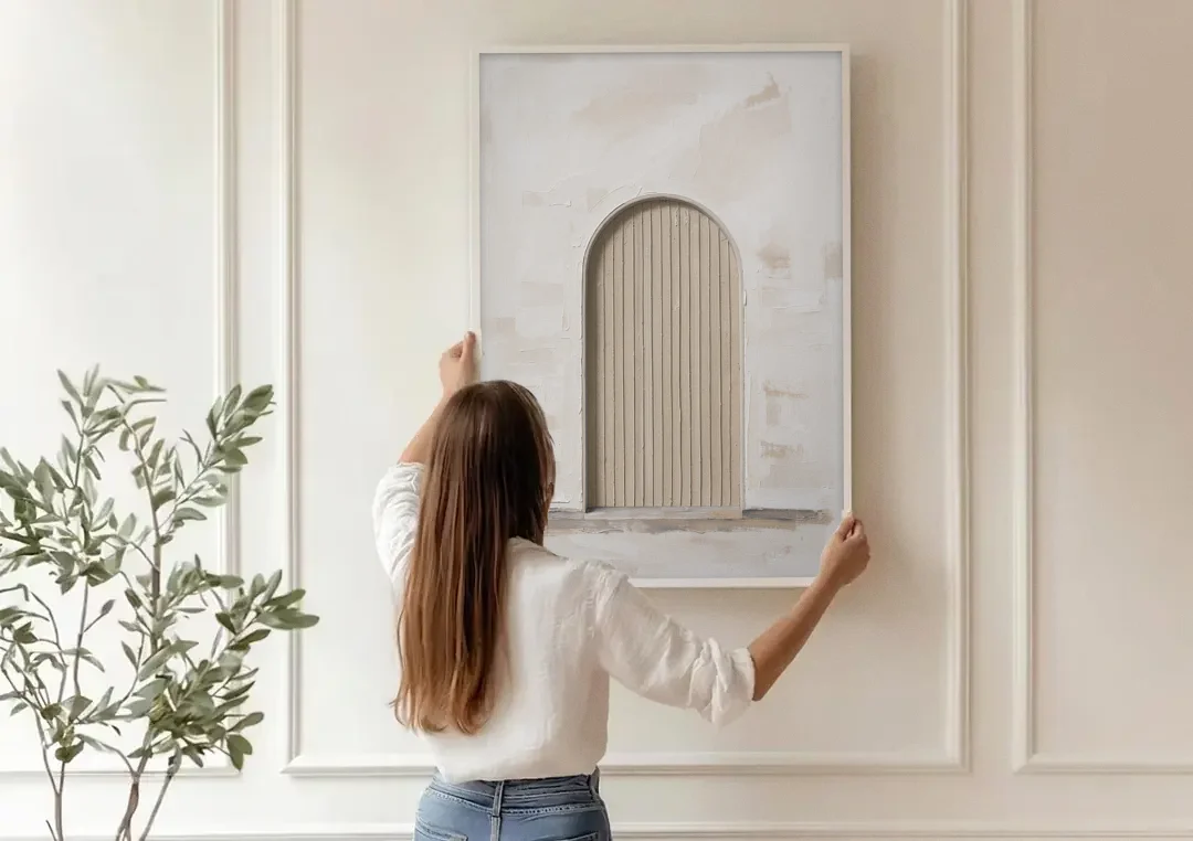 Scandinavian Wall Art Ribbed Beige Arch on Plinth canvas wall art being hung on a paneled wall