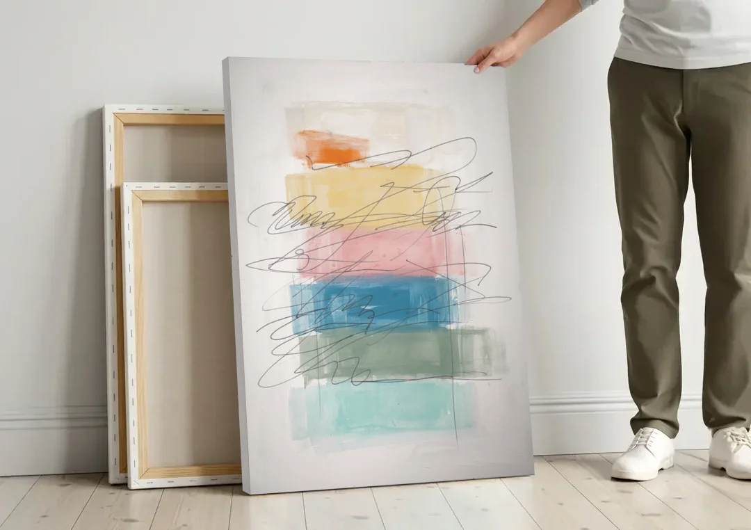 Scribble Abstract Art on Stacked Pastel Bands canvas wall art leaning against a wall next to blank canvases