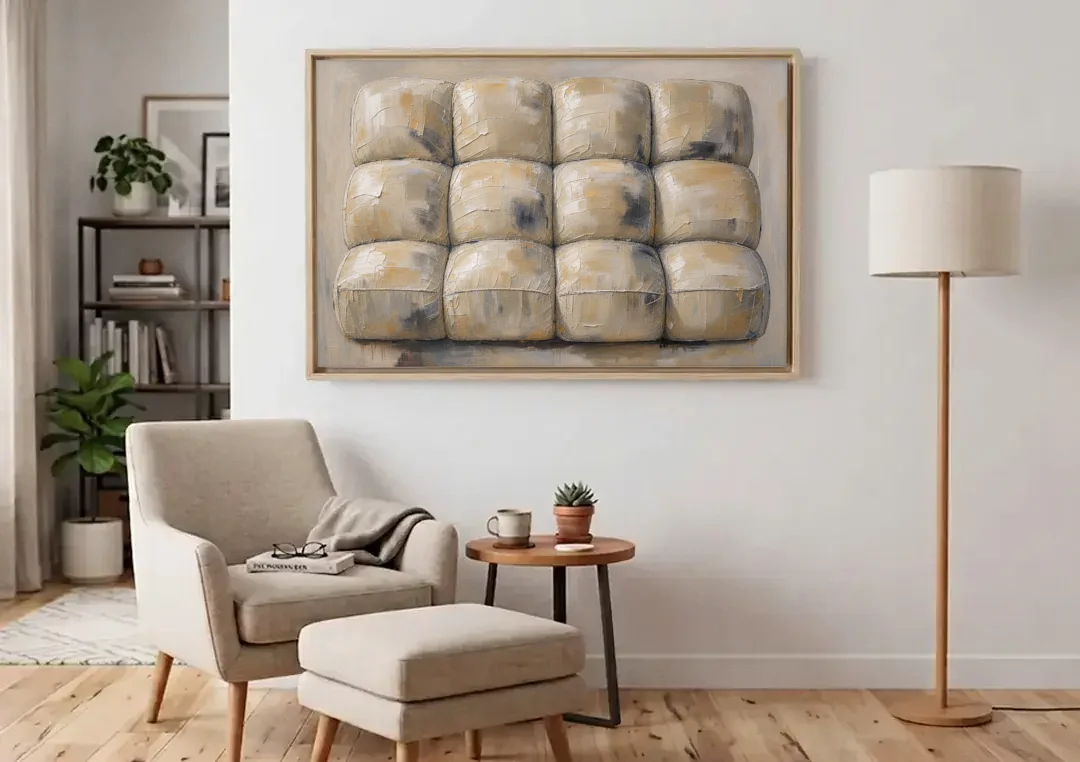 Sculptural Wall Art of Tufted Cream Pillows canvas wall art above an armchair in a bright living room