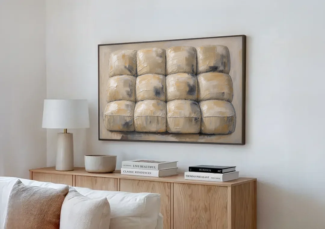 Sculptural Wall Art of Tufted Cream Pillows canvas wall art above a wooden sideboard next to a sofa