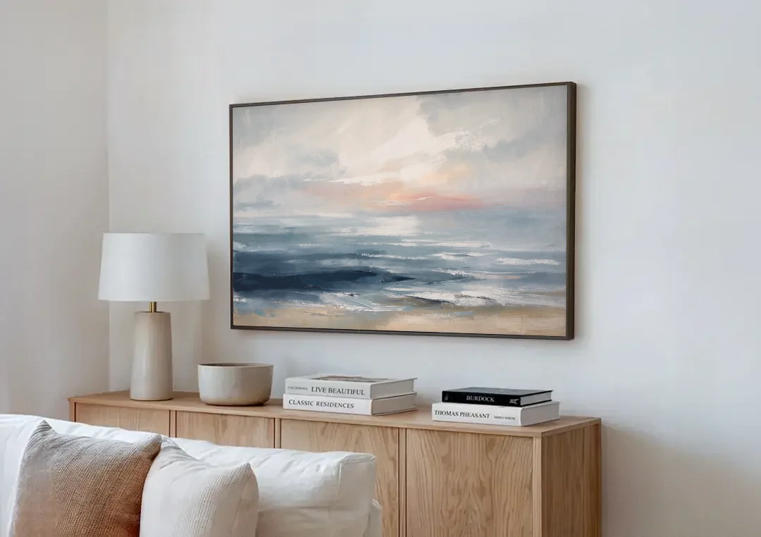 Seascape Painting of a Misty Dawn Horizon canvas wall art above a wooden sideboard next to a sofa