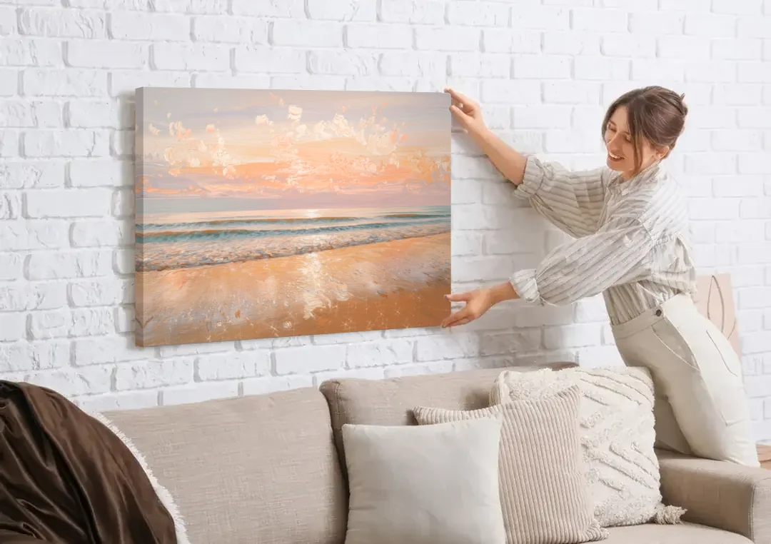 Seaside Waves And Sand canvas wall art being hung on a white brick wall above a sofa