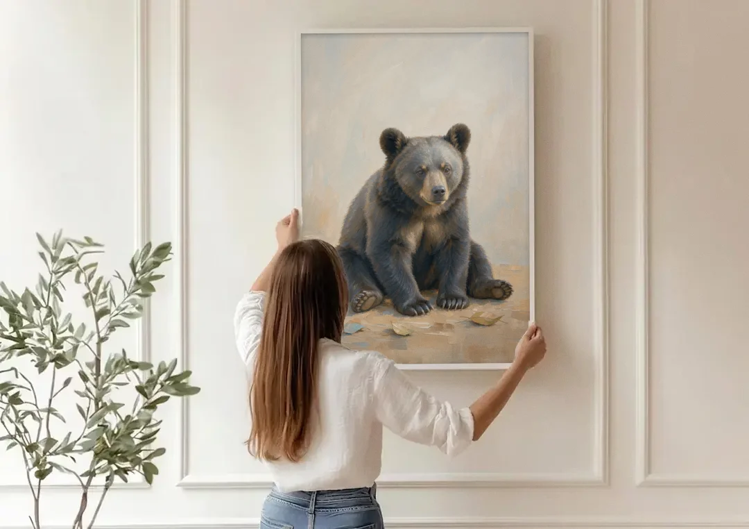 Seated Bear Cub with Fallen Leaves for the Nursery canvas wall art being hung on a paneled wall