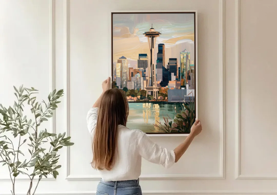 Seattle Space Needle and Cityscape canvas wall art being hung on a paneled wall