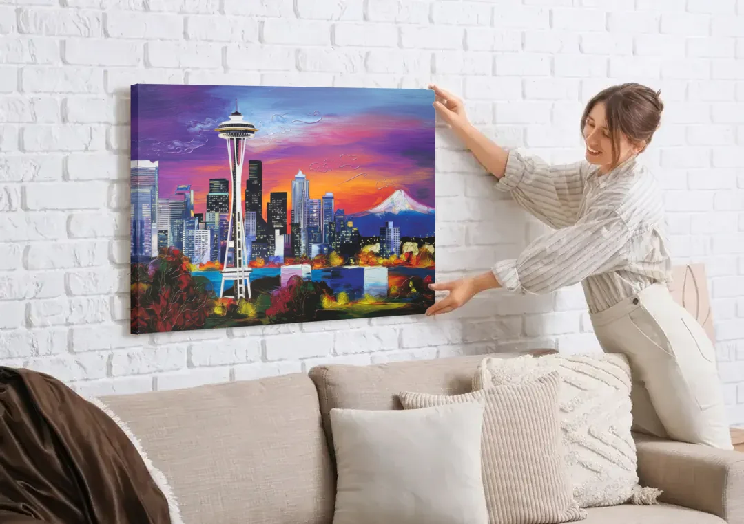 Seattle Space Needle View canvas wall art being hung on a white brick wall above a sofa