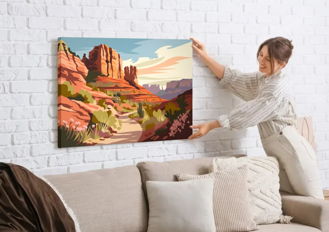 Sedona Canyon Trail Serenity canvas wall art being hung on a white brick wall above a sofa