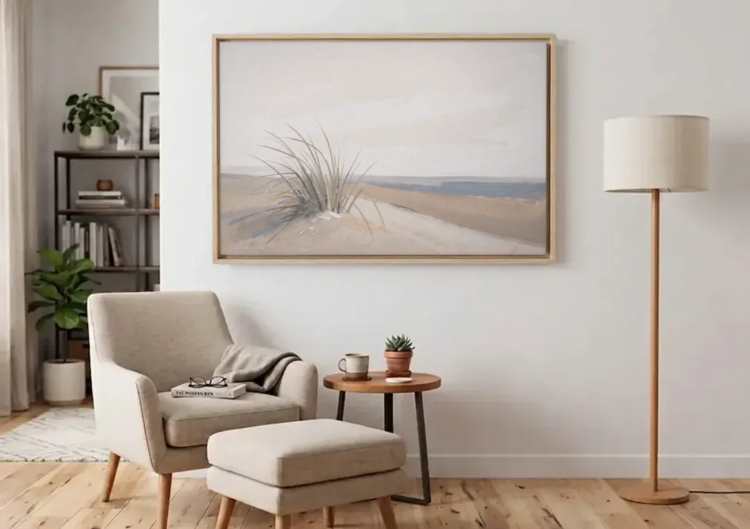 Set of 2 Wall Art with Windblown Dune Grass canvas wall art above an armchair in a bright living room