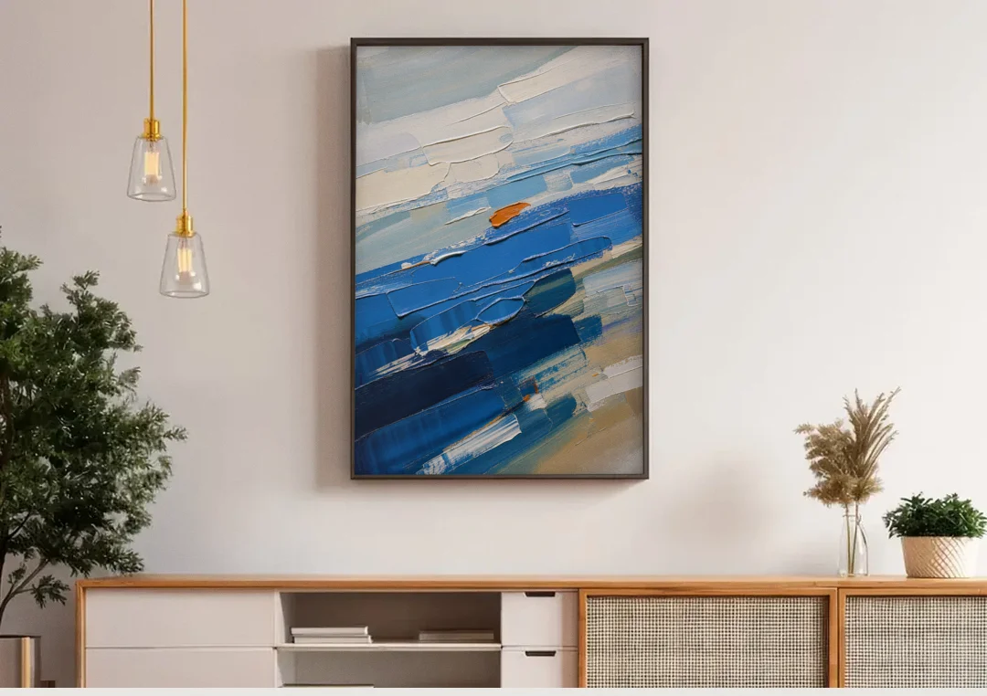 Set of Three Abstract Prints Blue Strata Triptych II canvas wall art above a wooden sideboard under pendant lights