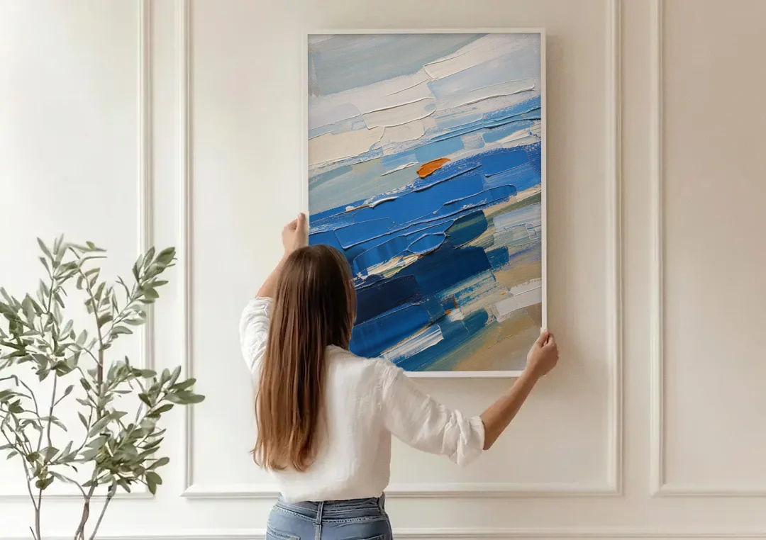 Set of Three Abstract Prints Blue Strata Triptych II canvas wall art being hung on a paneled wall