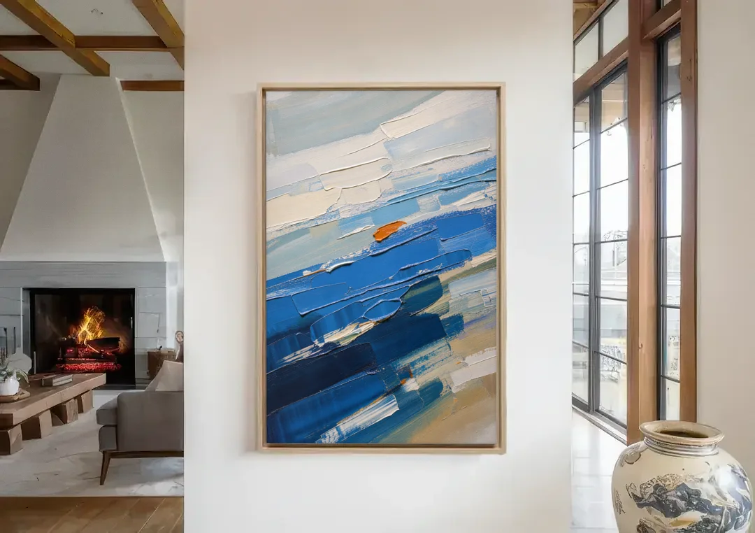 Set of Three Abstract Prints Blue Strata Triptych II canvas wall art in a living room with a fireplace