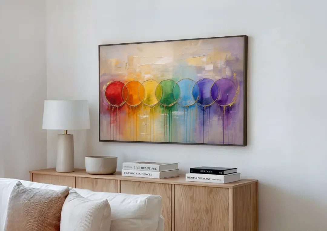 Seven Overlapping Chakra Circles with Gold Drips canvas wall art above a wooden sideboard next to a sofa