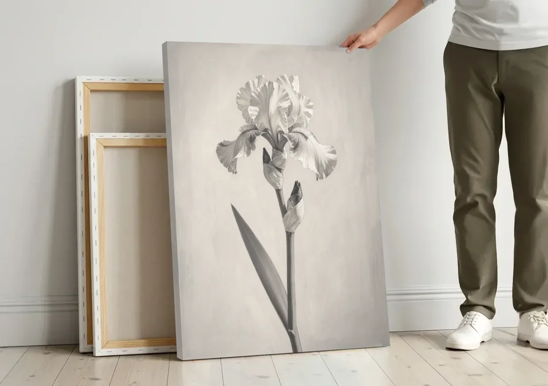 Single Flower Wall Art of a Bearded Iris canvas wall art leaning against a wall next to blank canvases