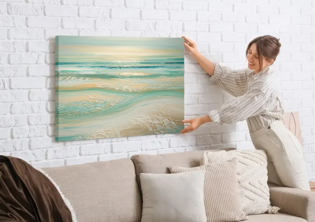 Sitka Ocean Breeze canvas wall art being hung on a white brick wall above a sofa