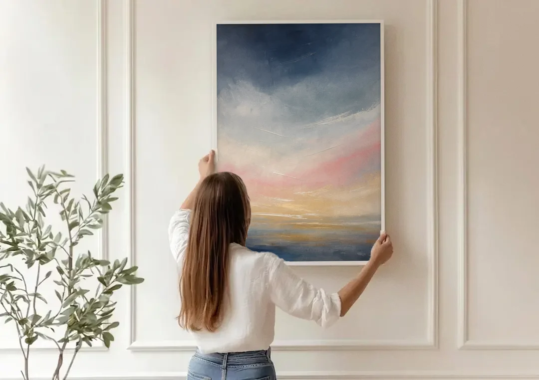 Sky Wall Art with a Blush Dawn Horizon canvas wall art being hung on a paneled wall