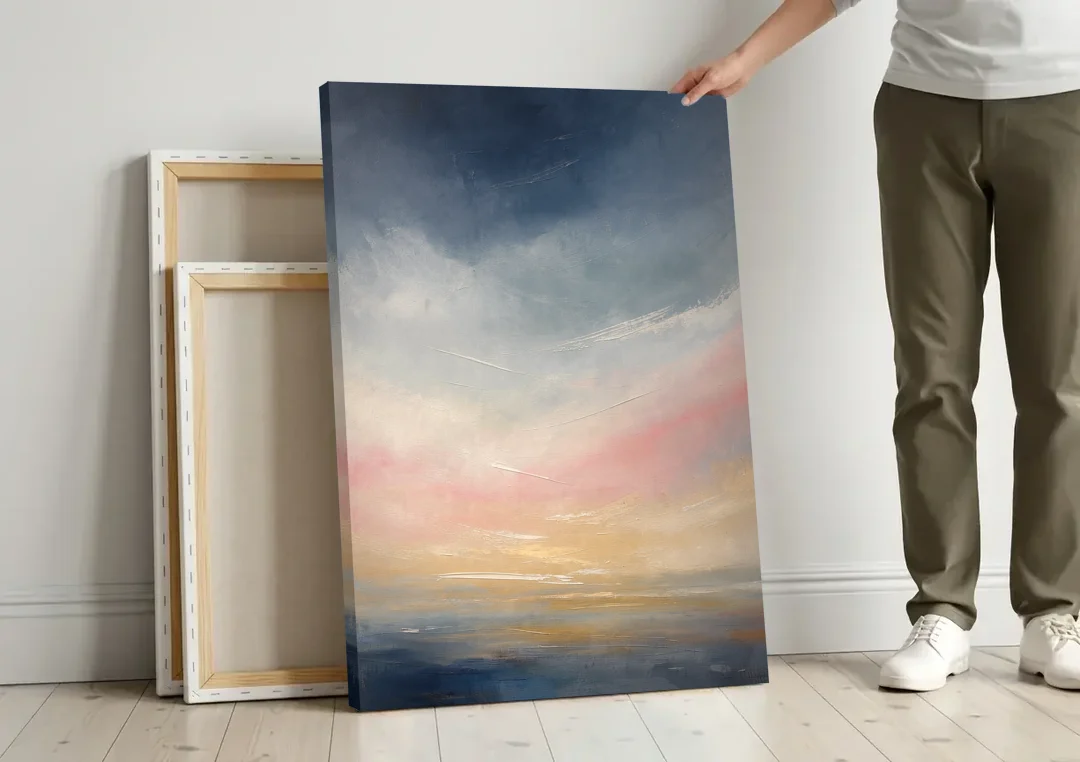 Sky Wall Art with a Blush Dawn Horizon canvas wall art leaning against a wall next to blank canvases