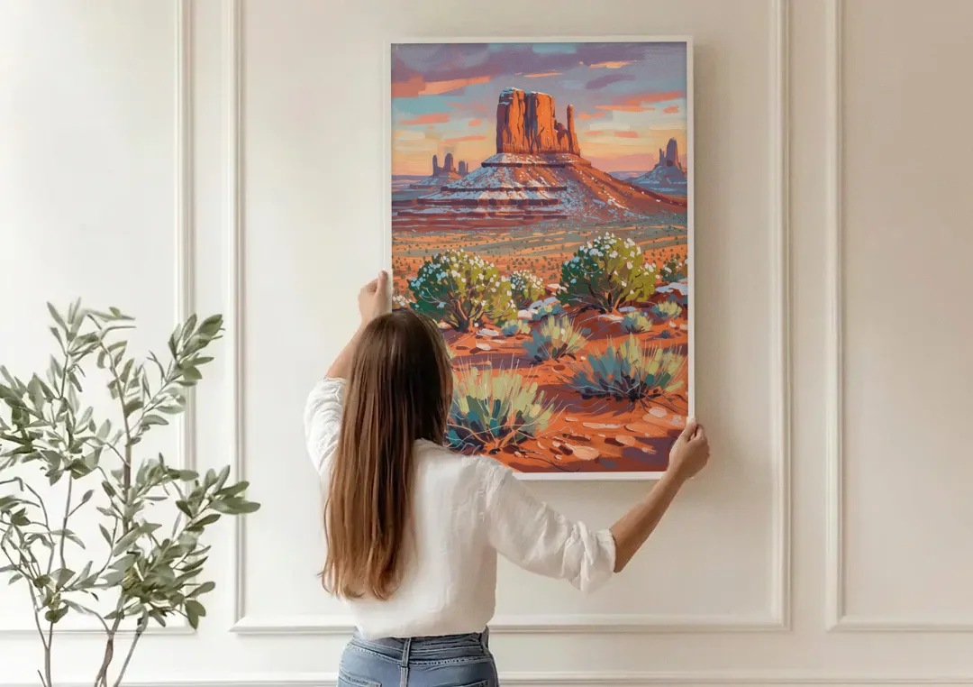 Winter Snow on the Red Rock Buttes canvas wall art being hung on a paneled wall