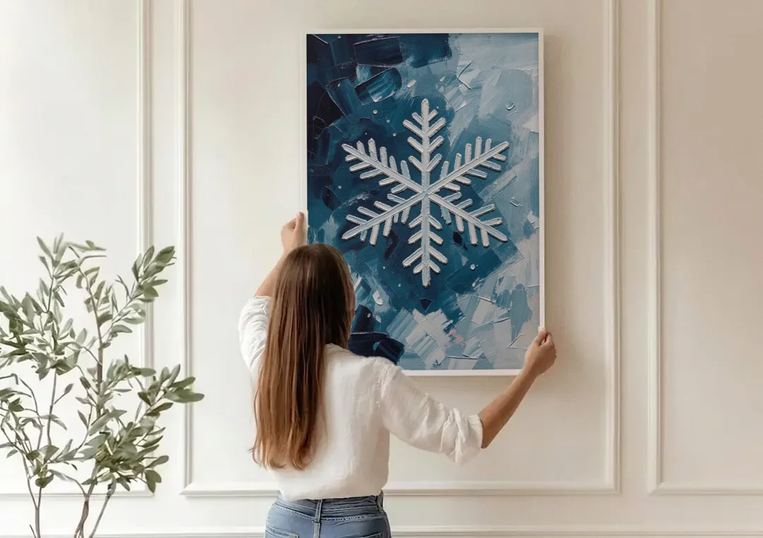 Snowflake Wall Art in Silver and Teal canvas wall art being hung on a paneled wall