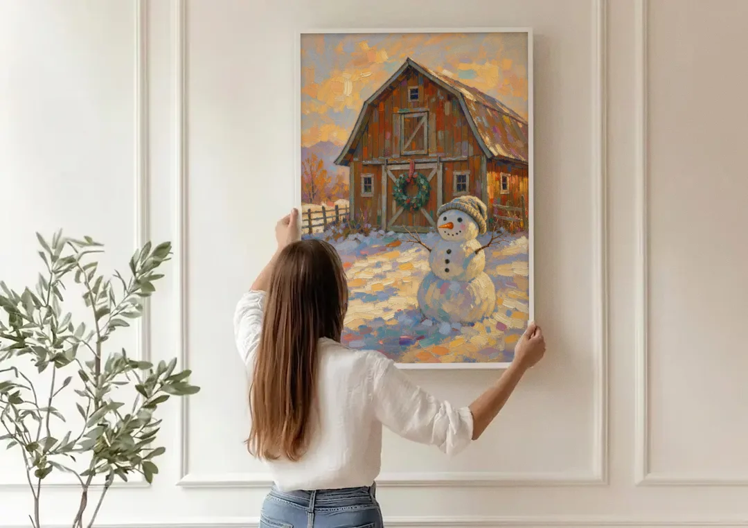 Snowman by the Red Barn with Wreath canvas wall art being hung on a paneled wall