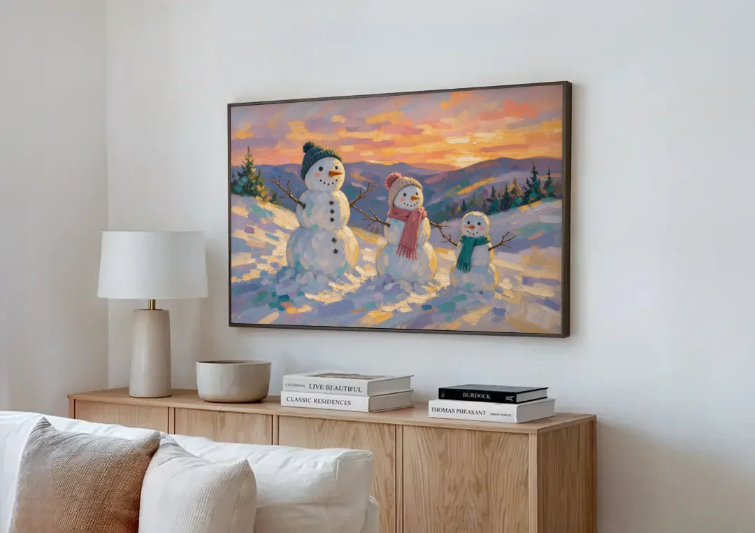 Snowman Family Painting on a Sunset Hill canvas wall art above a wooden sideboard next to a sofa