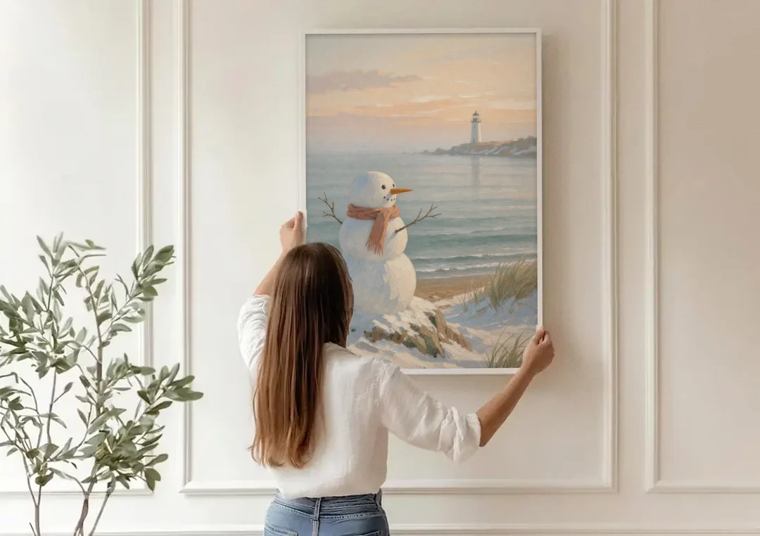 Snowman Watching the Coastal Lighthouse canvas wall art being hung on a paneled wall