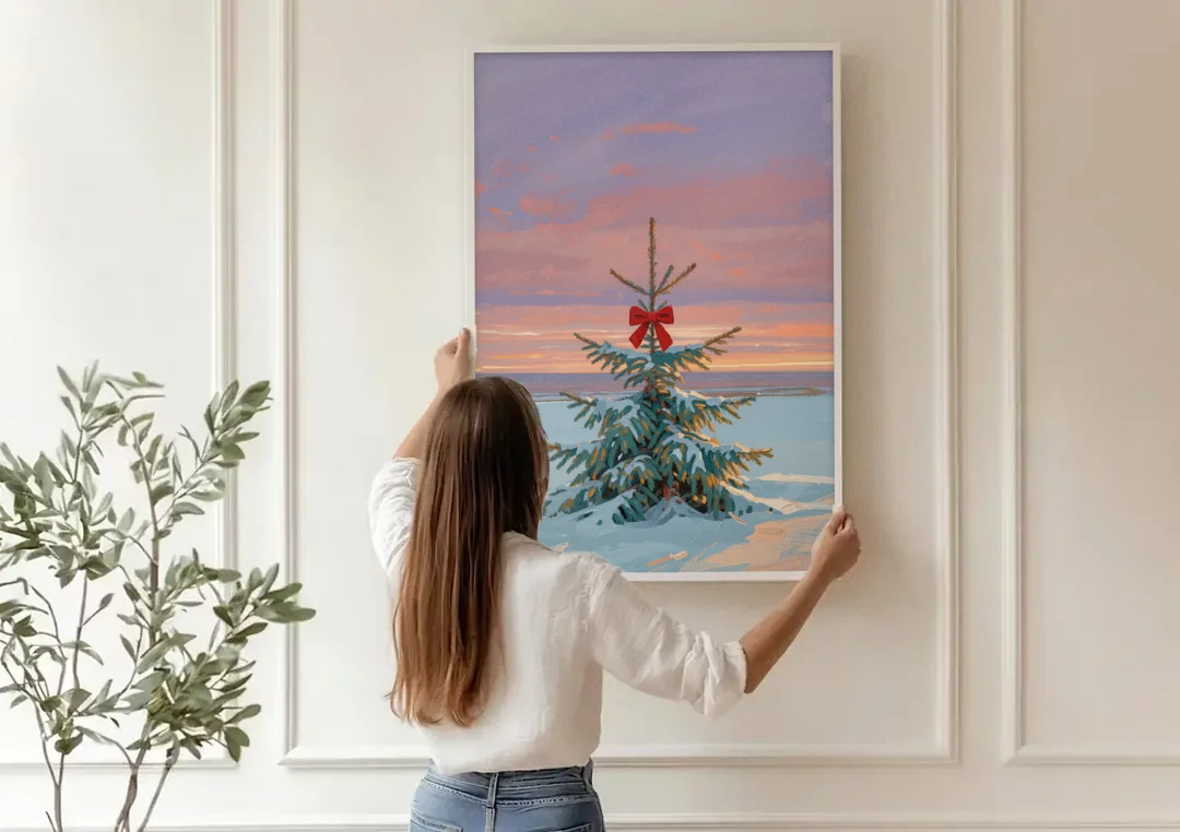 Snowy Fir with Red Bow at Twilight canvas wall art being hung on a paneled wall