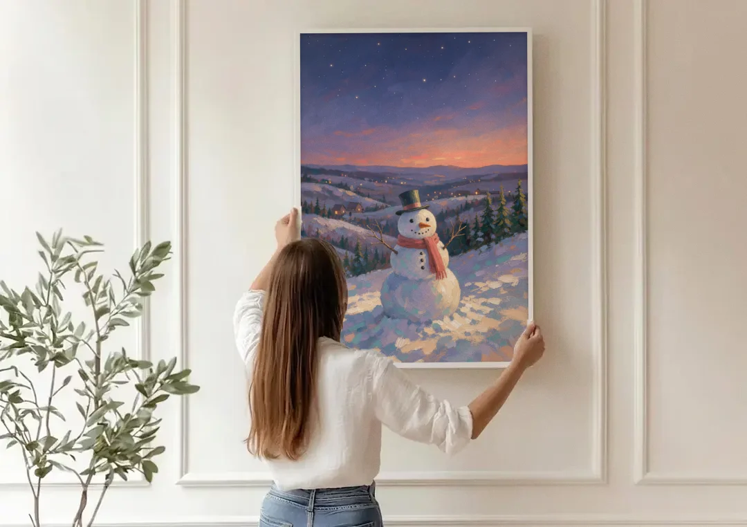 Snowy Night Painting with a Hilltop Snowman canvas wall art being hung on a paneled wall