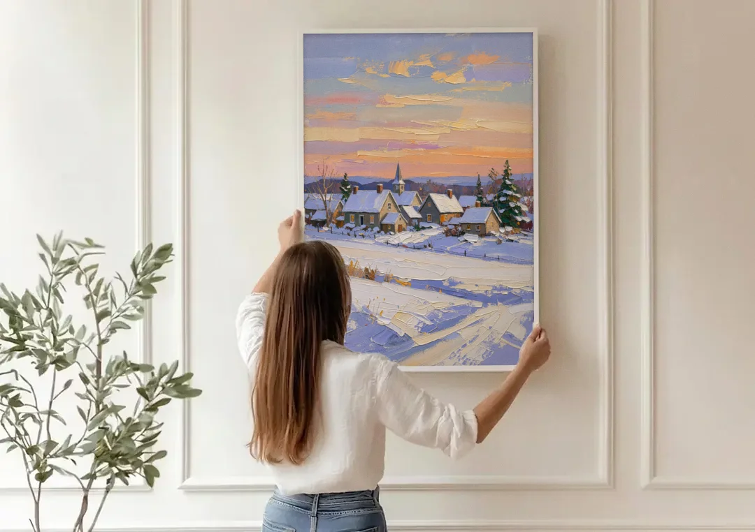 Snowy Village and Steeple at Dawn canvas wall art being hung on a paneled wall